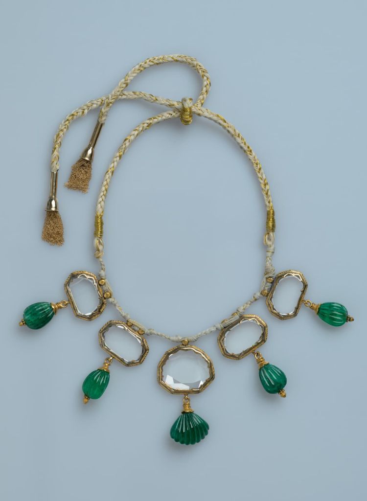 Full front view of the Mughal Mirror Diamond Necklace, five table-cut diamonds and carved emerald drops on a braided silk and gold cord.